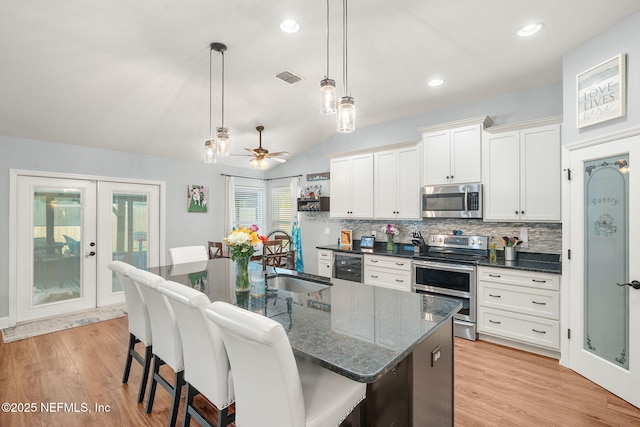 1770 High Brook Ct, Jacksonville, FL 32225 - kitchen featuring stainless steel appliances, a sink, tasteful backsplash, a breakfast bar area, and decorative light fixtures