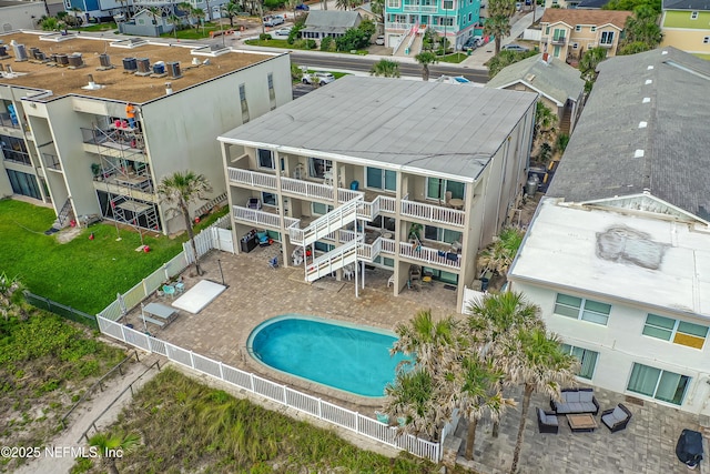 community pool with a fenced backyard