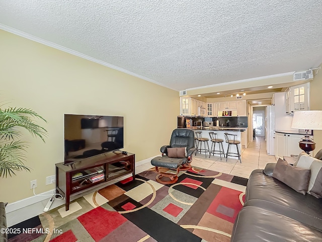 living area featuring ornamental molding, a textured ceiling, baseboards, and light tile patterned flooring