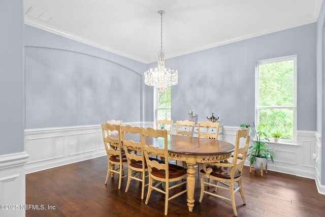 135 Tate Ln, Saint Johns, FL 32259 - dining space featuring dark wood-type flooring, a decorative wall, a chandelier, crown molding, and a wainscoted wall
