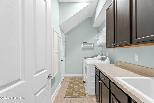 135 Tate Ln, Saint Johns, FL 32259 - laundry area featuring washing machine and clothes dryer, cabinet space, and light tile patterned flooring