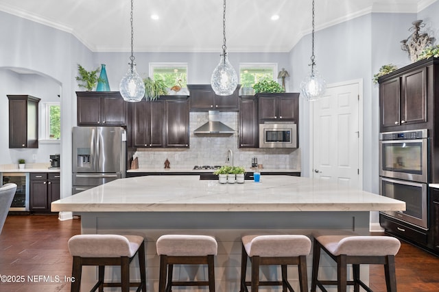 135 Tate Ln, Saint Johns, FL 32259 - kitchen featuring appliances with stainless steel finishes, beverage cooler, dark wood-type flooring, dark brown cabinets, and ornamental molding