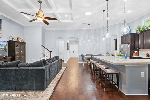 135 Tate Ln, Saint Johns, FL 32259 - kitchen featuring arched walkways, light countertops, a ceiling fan, a kitchen breakfast bar, and open floor plan
