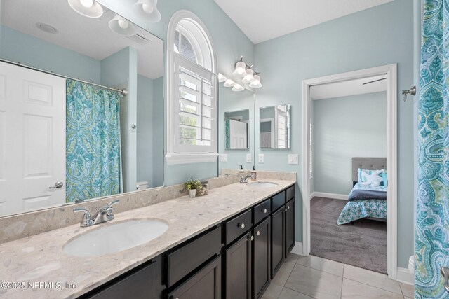 135 Tate Ln, Saint Johns, FL 32259 - ensuite bathroom featuring tile patterned floors, baseboards, double vanity, and toilet