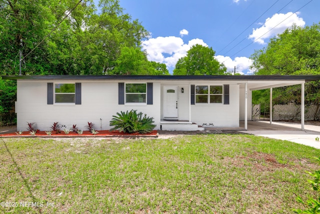 7420 Mayapple Rd, Jacksonville, FL 32211 - ranch-style house featuring concrete driveway, a front yard, and an attached carport
