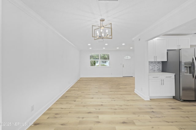 7420 Mayapple Rd, Jacksonville, FL 32211 - kitchen featuring stainless steel fridge with ice dispenser, crown molding, white cabinetry, a chandelier, and light wood-type flooring
