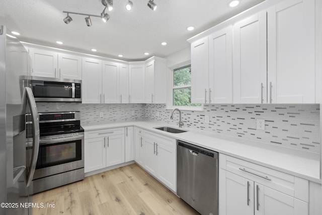 7420 Mayapple Rd, Jacksonville, FL 32211 - kitchen with appliances with stainless steel finishes, a sink, white cabinets, tasteful backsplash, and recessed lighting