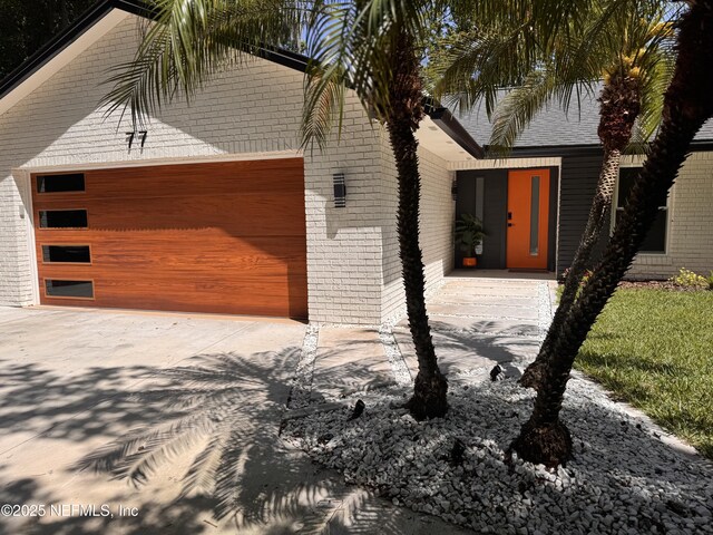 77 Sanchez Dr E, Ponte Vedra Beach, FL 32082 - view of home's exterior featuring concrete driveway and brick siding