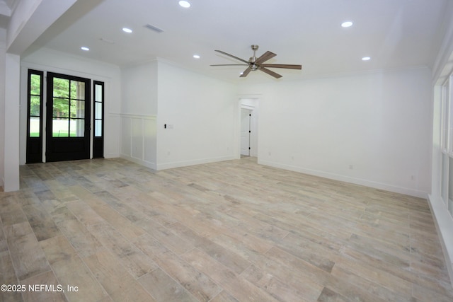 95121 N Ellis Landing Rd, Fernandina Beach, FL 32034 - unfurnished living room with recessed lighting, a ceiling fan, crown molding, light wood finished floors, and a wainscoted wall