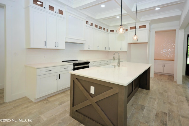 95121 N Ellis Landing Rd, Fernandina Beach, FL 32034 - kitchen with electric range, a sink, beamed ceiling, light wood-type flooring, and light countertops