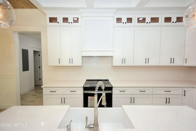 95121 N Ellis Landing Rd, Fernandina Beach, FL 32034 - kitchen featuring black electric range oven, crown molding, white cabinetry, and backsplash