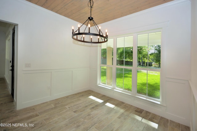95121 N Ellis Landing Rd, Fernandina Beach, FL 32034 - unfurnished dining area with healthy amount of natural light, a decorative wall, a chandelier, wood ceiling, and wood finished floors