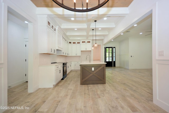 95121 N Ellis Landing Rd, Fernandina Beach, FL 32034 - kitchen with black electric range, beam ceiling, light countertops, light wood-style flooring, and a sink