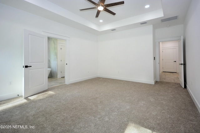 95121 N Ellis Landing Rd, Fernandina Beach, FL 32034 - unfurnished bedroom with light colored carpet, recessed lighting, a raised ceiling, and baseboards