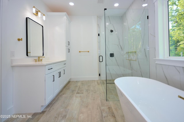 95121 N Ellis Landing Rd, Fernandina Beach, FL 32034 - full bath featuring a marble finish shower, vanity, a soaking tub, recessed lighting, and wood finished floors