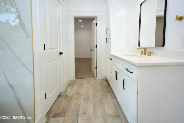95121 N Ellis Landing Rd, Fernandina Beach, FL 32034 - bathroom featuring wood finished floors, vanity, and recessed lighting
