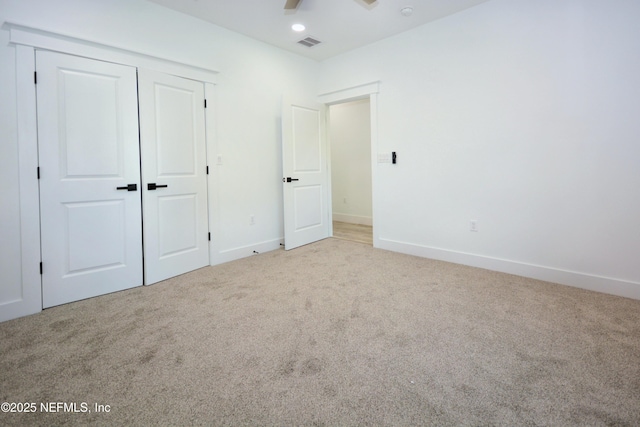 95121 N Ellis Landing Rd, Fernandina Beach, FL 32034 - unfurnished bedroom featuring carpet floors, a closet, baseboards, and a ceiling fan