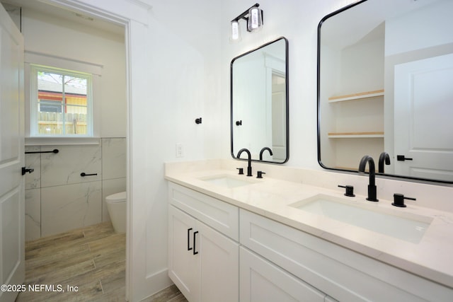 95121 N Ellis Landing Rd, Fernandina Beach, FL 32034 - full bath featuring tile walls, toilet, wood finished floors, and double vanity