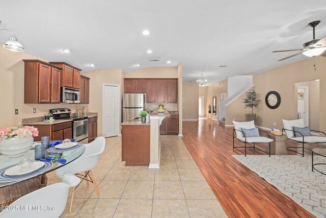 467 S Aberdeenshire Dr, Saint Johns, FL 32259 - kitchen featuring stainless steel appliances, open floor plan, ceiling fan, a kitchen island, and vaulted ceiling
