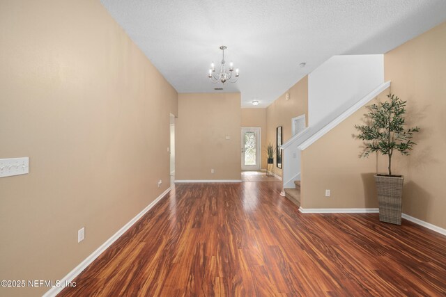 467 S Aberdeenshire Dr, Saint Johns, FL 32259 - spare room featuring a chandelier, wood finished floors, stairway, and baseboards