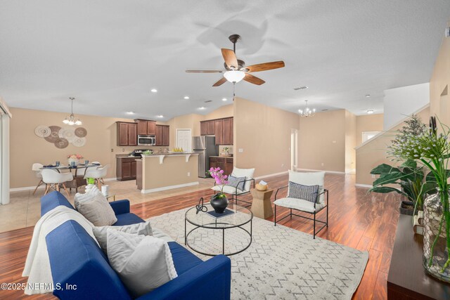 467 S Aberdeenshire Dr, Saint Johns, FL 32259 - living area featuring a chandelier, a ceiling fan, vaulted ceiling, and light wood-style floors