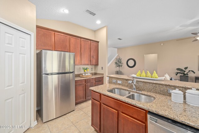 467 S Aberdeenshire Dr, Saint Johns, FL 32259 - kitchen with stainless steel appliances, a sink, light tile patterned floors, light stone countertops, and ceiling fan