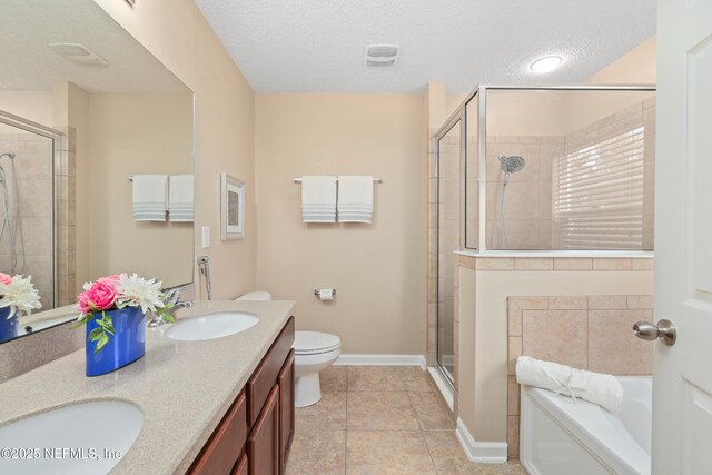 467 S Aberdeenshire Dr, Saint Johns, FL 32259 - bathroom with a stall shower, a bath, double vanity, tile patterned floors, and a textured ceiling