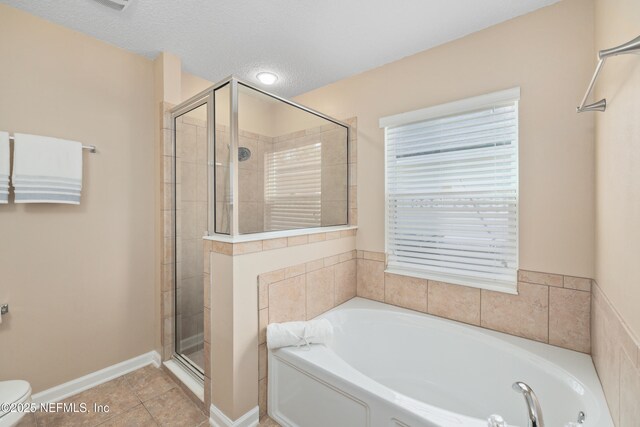 467 S Aberdeenshire Dr, Saint Johns, FL 32259 - bathroom featuring a stall shower, a bath, tile patterned flooring, toilet, and a textured ceiling
