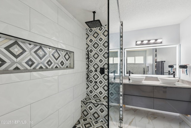 3100 Hickory Glen Dr, Orange Park, FL 32065 - bathroom with a tile shower, marble look tile flooring, double vanity, and a textured ceiling