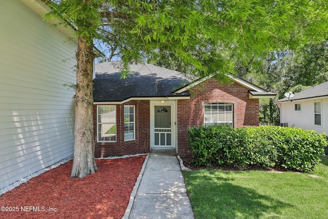 3100 Hickory Glen Dr, Orange Park, FL 32065 - view of front facade featuring brick siding, a shingled roof, and a front yard