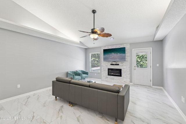 3100 Hickory Glen Dr, Orange Park, FL 32065 - living room featuring light marble finish floors, a fireplace, a ceiling fan, a textured ceiling, and baseboards