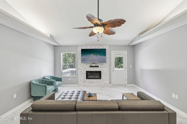 3100 Hickory Glen Dr, Orange Park, FL 32065 - living area featuring a textured ceiling, ceiling fan, a large fireplace, and baseboards
