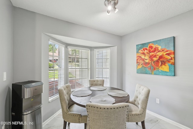 3100 Hickory Glen Dr, Orange Park, FL 32065 - dining room with light marble finish floors, baseboards, and a textured ceiling