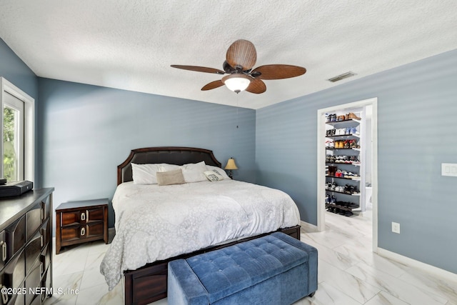 3100 Hickory Glen Dr, Orange Park, FL 32065 - bedroom with light marble finish floors, a textured ceiling, a ceiling fan, baseboards, and a spacious closet
