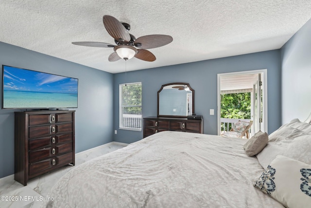3100 Hickory Glen Dr, Orange Park, FL 32065 - bedroom with access to outside, marble finish flooring, multiple windows, a textured ceiling, and baseboards
