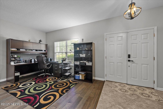 8719 Derry Dr, Jacksonville, FL 32244 - home office featuring wood finished floors, baseboards, and a textured ceiling
