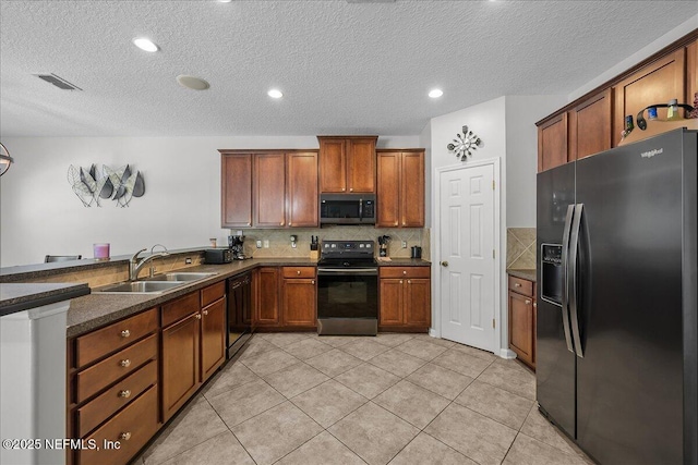 8719 Derry Dr, Jacksonville, FL 32244 - kitchen with black appliances, a sink, a peninsula, tasteful backsplash, and brown cabinetry