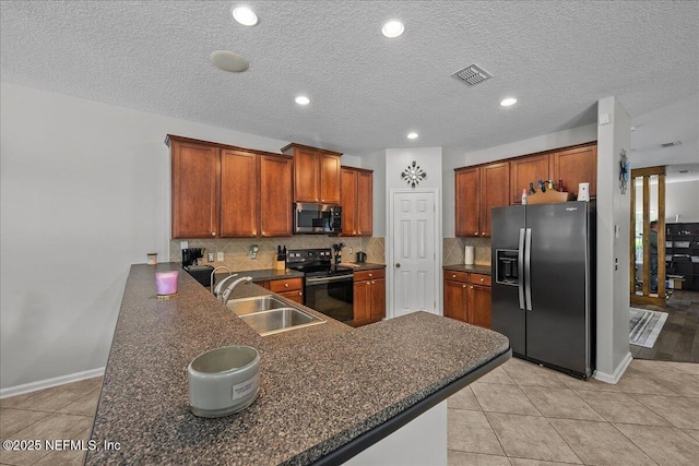8719 Derry Dr, Jacksonville, FL 32244 - kitchen with refrigerator with ice dispenser, black electric range, stainless steel microwave, a sink, and dark countertops