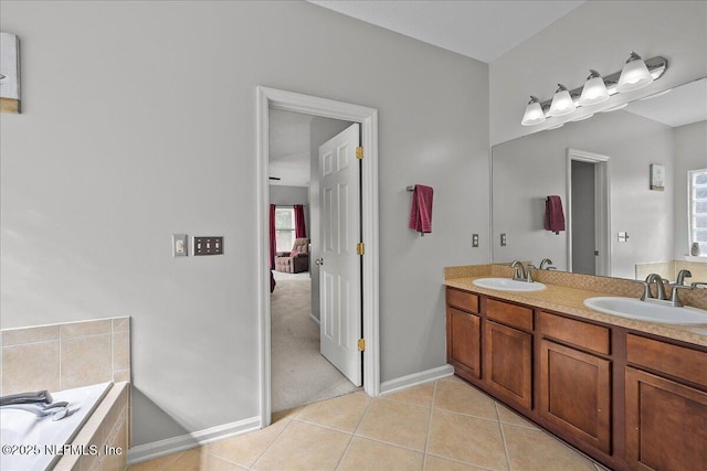 8719 Derry Dr, Jacksonville, FL 32244 - full bath with tile patterned flooring, baseboards, double vanity, and tiled bath