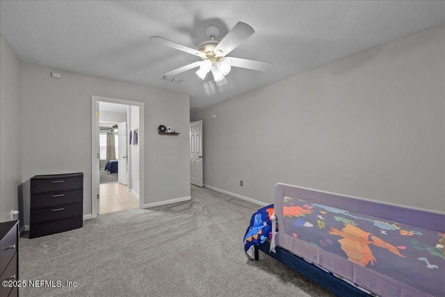 8719 Derry Dr, Jacksonville, FL 32244 - bedroom featuring carpet floors, a textured ceiling, ceiling fan, and baseboards