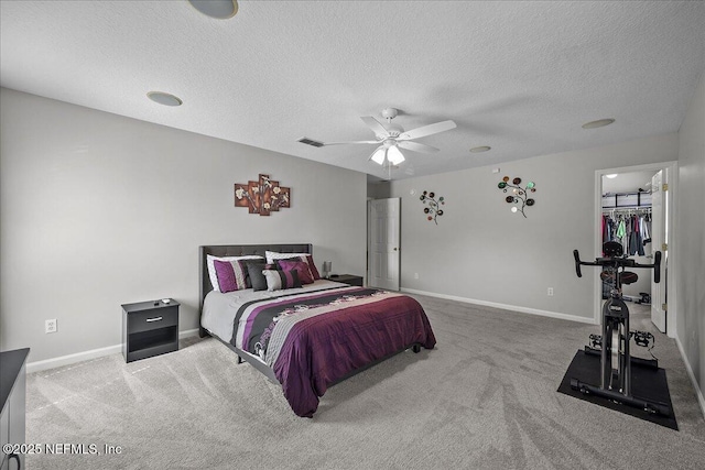 8719 Derry Dr, Jacksonville, FL 32244 - bedroom with carpet, baseboards, a textured ceiling, a spacious closet, and ceiling fan