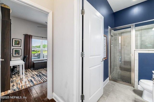 2035 Arden Forest Pl, Fleming Island, FL 32003 - full bathroom featuring a stall shower, toilet, baseboards, and wood finished floors