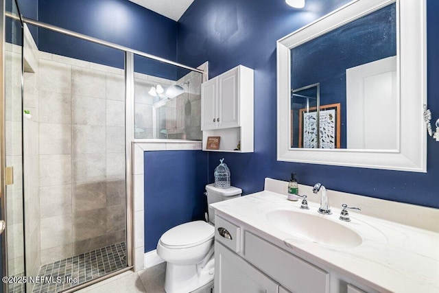 2035 Arden Forest Pl, Fleming Island, FL 32003 - bathroom featuring a shower stall, toilet, vanity, and tile patterned flooring