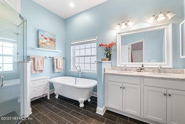 2035 Arden Forest Pl, Fleming Island, FL 32003 - bathroom with a shower stall, baseboards, double vanity, a freestanding bath, and recessed lighting