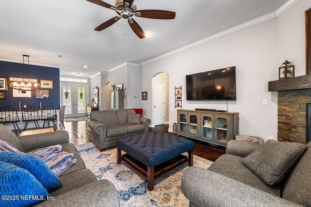 2035 Arden Forest Pl, Fleming Island, FL 32003 - living area featuring wood finished floors, ornamental molding, a ceiling fan, arched walkways, and a textured ceiling