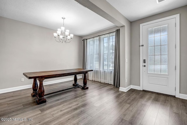 23 Catesby Ln, Saint Augustine, FL 32095 - foyer entrance with a chandelier, baseboards, and wood finished floors