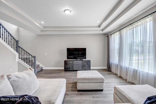 23 Catesby Ln, Saint Augustine, FL 32095 - living room featuring stairway, baseboards, a tray ceiling, wood finished floors, and recessed lighting