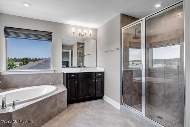 23 Catesby Ln, Saint Augustine, FL 32095 - bathroom with a stall shower, a chandelier, a garden tub, vanity, and tile patterned floors