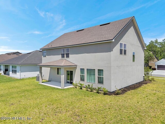 23 Catesby Ln, Saint Augustine, FL 32095 - rear view of property with a patio area, roof with shingles, a yard, and stucco siding