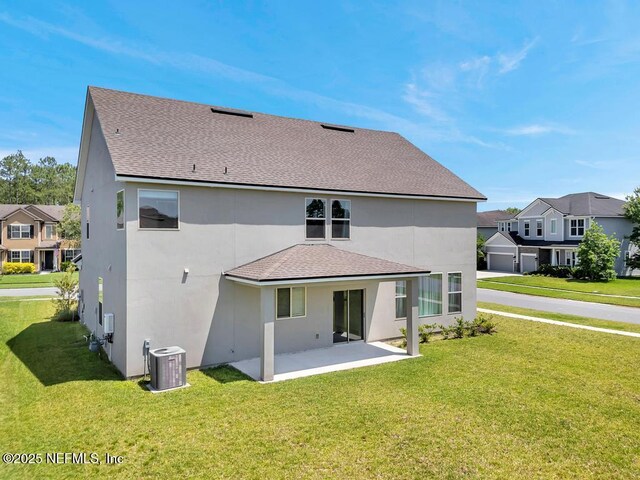 23 Catesby Ln, Saint Augustine, FL 32095 - rear view of property with central AC unit, a patio, a yard, and a shingled roof